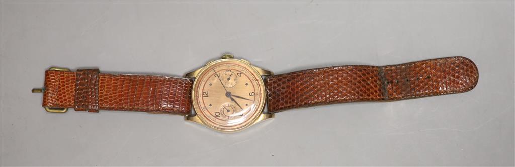 A Swiss 18k yellow metal chronograph manual wind wrist watch, on associated leather strap, with a Garrard & Co box.